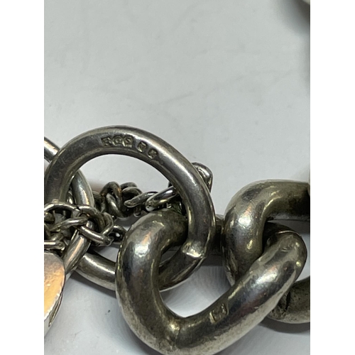 579 - A HEAVY SILVER WRIST CHAIN WITH HEART PADLOCK