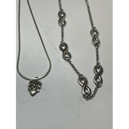 586 - FOUR SILVER NECKLACES AND PENDANTS