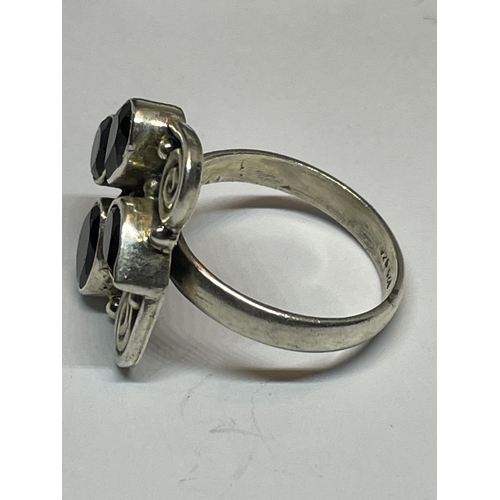 597 - A SILVER DESIGNER RING IN A PRESENTATION BOX