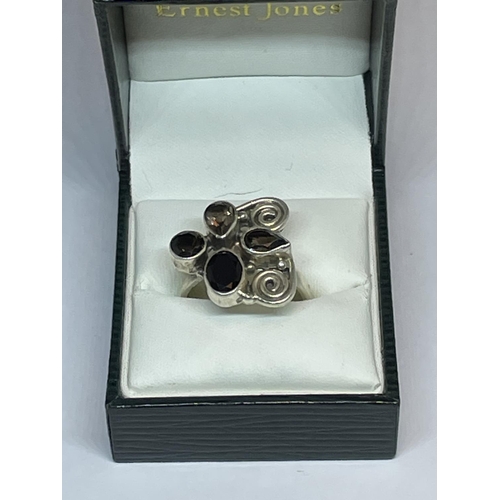 597 - A SILVER DESIGNER RING IN A PRESENTATION BOX