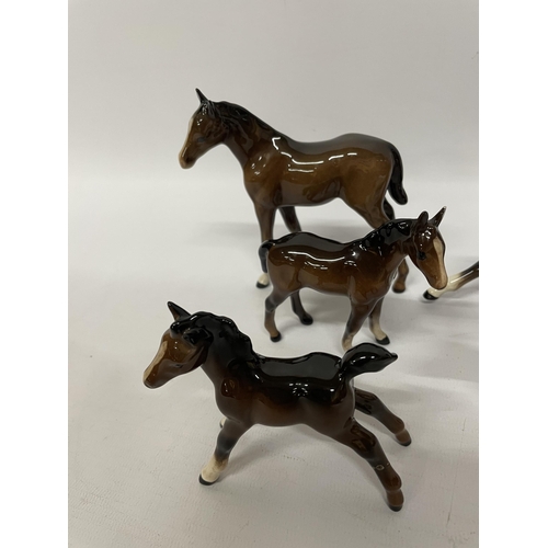 704 - FIVE BESWICK GLOSS ANIMAL MODELS - FOUR PONIES AND A JACK RUSSELL DOG