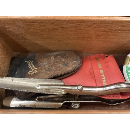 192 - A WOODEN BOX CONTAINING ASSORTED BADGES, CAR BADGES ETC