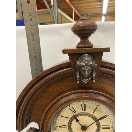 15 - A VINTAGE OAK CHIMING MANTLE CLOCK WITH COLUMN SUPPORTS HAVING LION HEAD DESIGN, WITH PENDULUM, HEIG... 