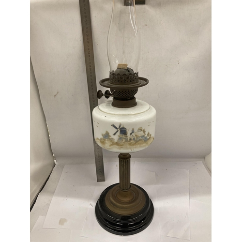 33 - A VINTAGE OIL LAMP WITH BRASS CORINTHIAN COLUMN SUPPORT AND PAINTED WINDMILL SCENE RESEVOIR