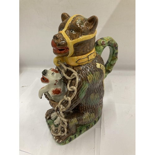 6 - A MAJOLICA STYLE BEAR JUG DEPICTING A CHAINED BEAR HOLDING A DOG, DOGS ARM A/F