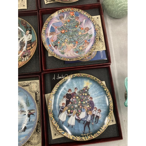 299 - A GROUP OF SIX BOXED A FAMILY CHRISTMAS CABINET PLATES