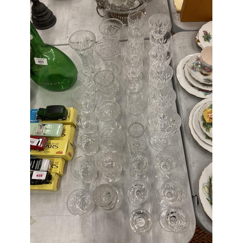 801 - A LARGE COLLECTION OF CUT GLASS DRINKING GLASSES