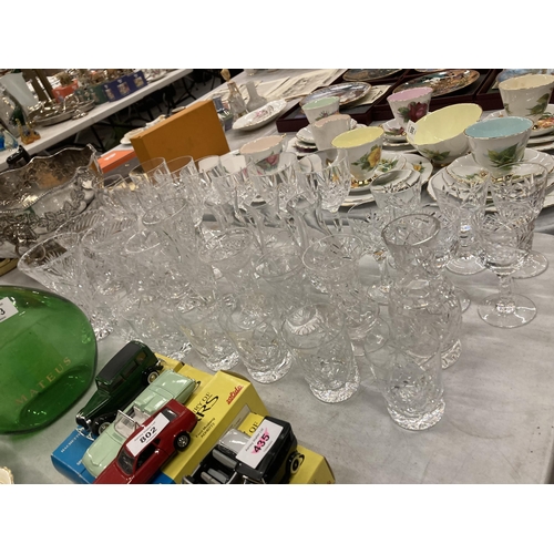 801 - A LARGE COLLECTION OF CUT GLASS DRINKING GLASSES