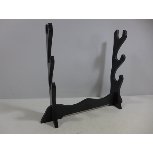 318 - A 'THREE SWORD' RACK, WIDTH 40CM, HEIGHT 35CM