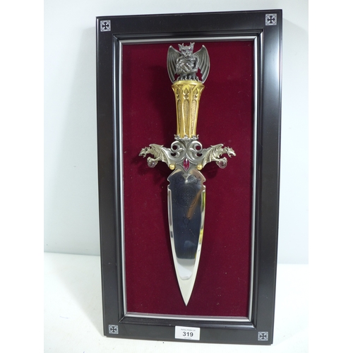 319 - A FANTASY DAGGER MOUNTED ON A WOODEN FRAME, 22CM DOUBLE EDGED BLADE, GRIP WITH DRAGONS HOLDING CRYST... 