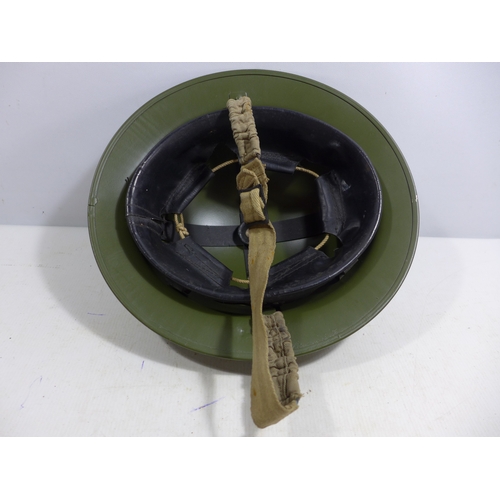 332 - A MID 20TH CENTURY GREEN PAINTED METAL BRITISH HELMET AND LINER