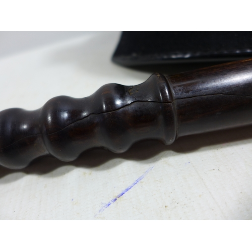 335 - A WORLD WAR I WHISTLE DATED 1915, HARDWOOD POLICE TRUNCHEON, LENGTH 38CM AND A POLICE HELMET (3)