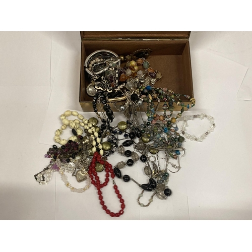 136 - A QUANTITY OF COSTUME JEWELLERY TO INCLUDE NECKLACES, BANGLES, ETC IN A VINTAGE BRASS BOX WITH WILD ... 