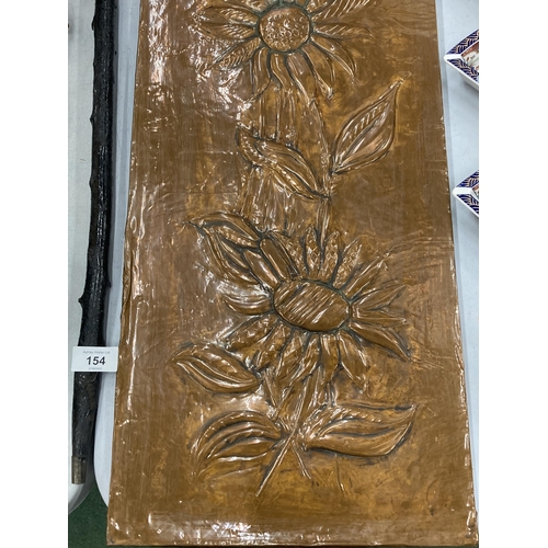 153 - AN ARTS AND CRAFTS COPPER PANEL, WITH WOODEN BACK AND FLORAL DESIGN, 30CM X 88CM