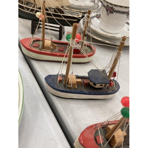 158 - A COLLECTION OF SEVEN SMALL WOODEN MODEL BOATS