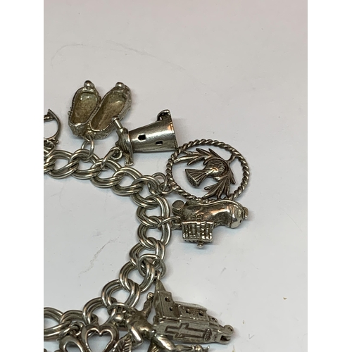 622 - A SILVER CHARM BRACELET WITH FIFTEEN CHARMS