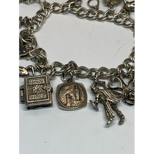 622 - A SILVER CHARM BRACELET WITH FIFTEEN CHARMS