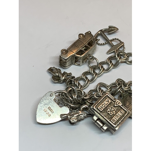 622 - A SILVER CHARM BRACELET WITH FIFTEEN CHARMS