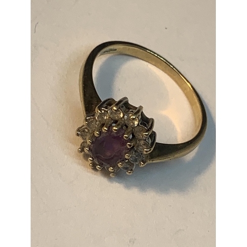 548 - A 9 CARAT GOLD RING WITH CENTRE AMETHYST SURROUNDED BY CUBIC ZIRCONIAS SIZE N/O