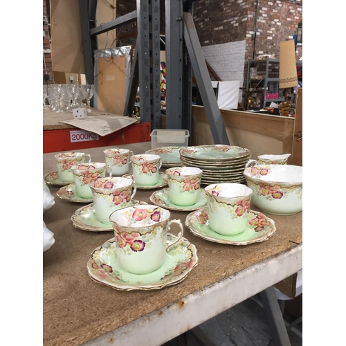 1054 - A VICTORIAN TEASET IN PALE GREEN WITH FLORAL PATTERN TO INCLUDE A CAKE PLATE, CUPS, SAUCERS, SIDE PL... 