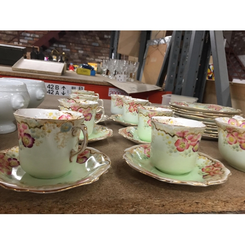 1054 - A VICTORIAN TEASET IN PALE GREEN WITH FLORAL PATTERN TO INCLUDE A CAKE PLATE, CUPS, SAUCERS, SIDE PL... 