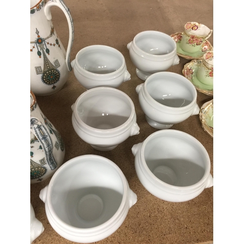 1055 - THREE GRADUATED LYONS JUGS, SOUP BOWLS AND A SERVING DISH