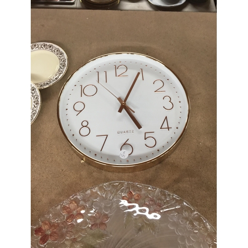 1056 - A LARGE FLORAL PATTERNED GLASS PLATE PLUS A WALL CLOCK