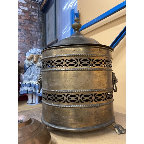 838 - A LARGE BRASS LIDDED COAL BUCKET WITH LIONS HEAD HANDLES PLUS A COPPER FOOT WARMER