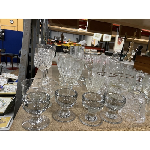 1101 - A LARGE QUANTITY OF GLASSES TO INCLUDE CHAMPAGNE FLUTES, BRANDY BALLOONS, WINE, SHERRY, TANKARDS, ET... 