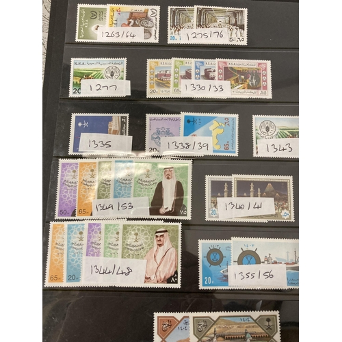 471 - A FOLDER CONTAINING SAUDI ARABIAN, CEYLON, SRI LANKA, SINGPORE AND SIRIYAN STAMPS