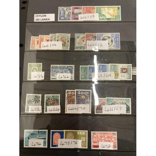 471 - A FOLDER CONTAINING SAUDI ARABIAN, CEYLON, SRI LANKA, SINGPORE AND SIRIYAN STAMPS