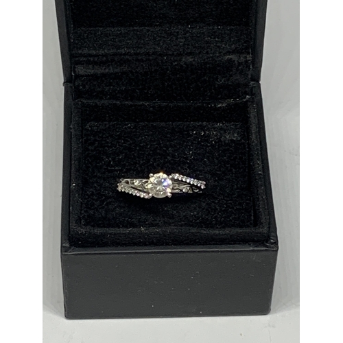 511 - A LOVESTORY 14 CARAT WHITE GOLD DIAMOND SOLITAIRE RING WITH DIAMONDS TO THE SHOULDERS SIZE L/M