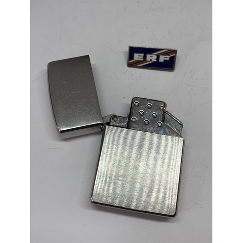 538 - A MADE IN USA ZIPPO LIGHTER AND AN ENAMEL ERF BADGE