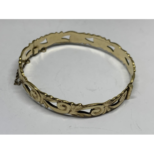 651 - A DECORATIVE GOLD PLATED BANGLE