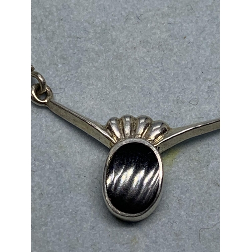 689 - A SILVER NECKLACE WITH A BLACK STONE IN A PRESENTATION BOX