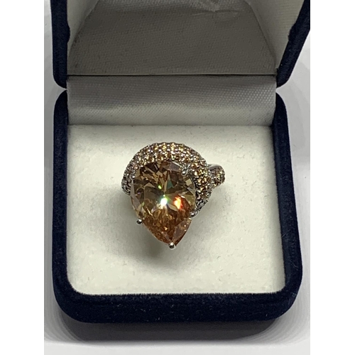 690 - A SILVER RING WITH LARGE AMBER STONE SIZE J/K IN A PRESENTATION BOX