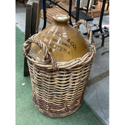 100 - A LARGE F T MORRELL & CO 105-107 GT ANCOATS STREET MANCHESTER STONEWARE VESSEL IN A WICKER BASKET