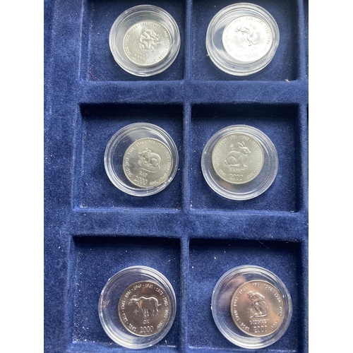 354A - SOMALIA , A SELECTION OF 12 ENCAPSULATED TEN SHILLING COINS FROM 2000