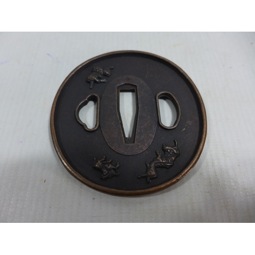 344 - A JAPANESE BRONZE TSUBA DECORATED WITH MYTHICAL BEASTS, DIAMETER 8CM