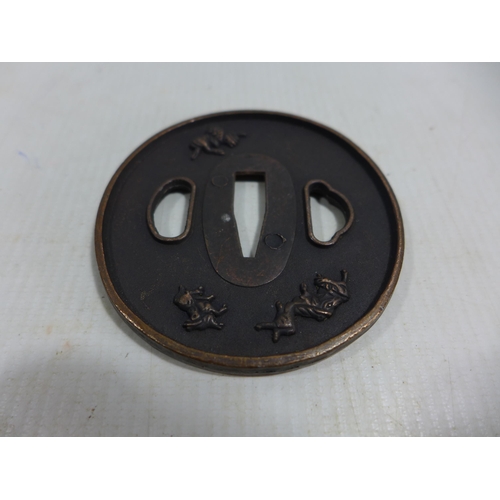 344 - A JAPANESE BRONZE TSUBA DECORATED WITH MYTHICAL BEASTS, DIAMETER 8CM