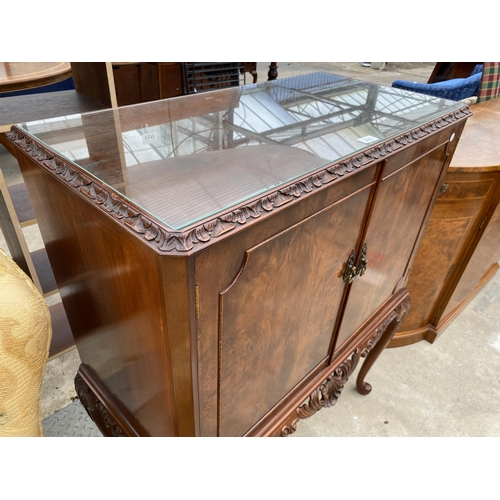 2583 - A WALNUT TWO DOOR COCKTAIL CABINET WITH CARVED RAIL, ON CABRIOLE LEGS, 35