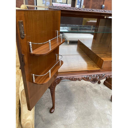 2583 - A WALNUT TWO DOOR COCKTAIL CABINET WITH CARVED RAIL, ON CABRIOLE LEGS, 35