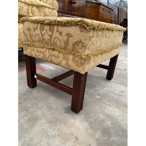 2584 - A GEORGE III STYLE SPRUNG AND UPHOLSTERED WINGED EASY CHAIR AND STOOL