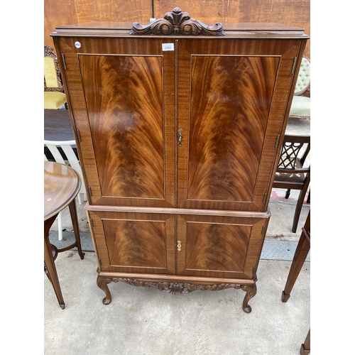 2592 - A MAHOGANY FOUR DOOR COCKTAIL CABINET WITH PULL-OUT SLIDE, ON CABRIOLE LEGS, 33.5