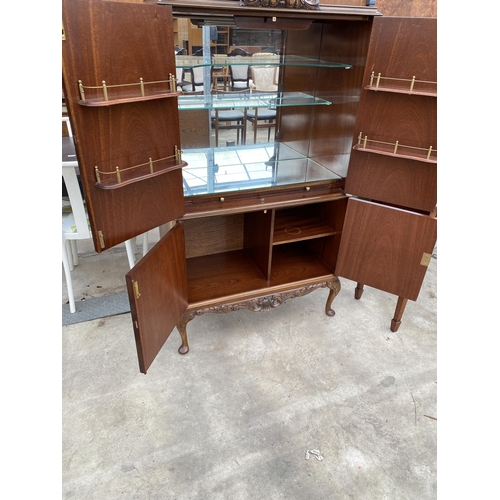 2592 - A MAHOGANY FOUR DOOR COCKTAIL CABINET WITH PULL-OUT SLIDE, ON CABRIOLE LEGS, 33.5