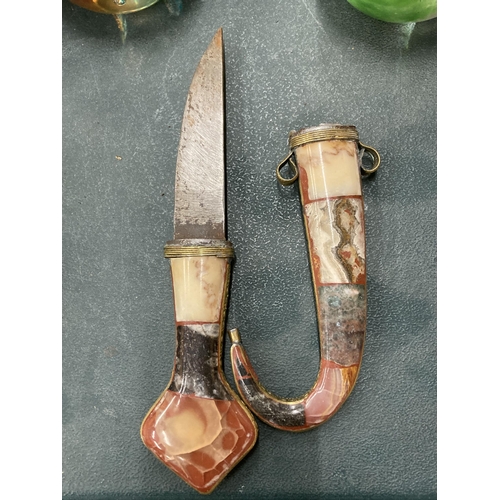 109 - A VINTAGE MIDDLE EASTERN DAGGER EMBOSSED IN BRASS AND SEMI PRECIOUS STONE