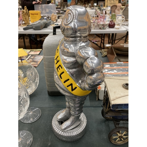 135 - A VERY HEAVY MICHELIN MAN ON A TYRE, HEIGHT APPROX 37CM