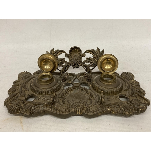 10 - A VINTAGE, POSSIBLY FRENCH, FLORAL DESIGN BRASS DOUBLE INKWELL STAND