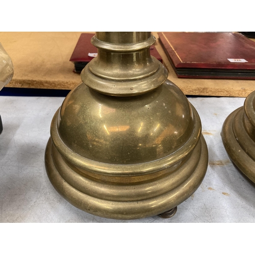 25 - A PAIR OF ECCLESIASTICAL TOWER DESIGN BRASS COLUMN ALTAR CANDLESTICKS