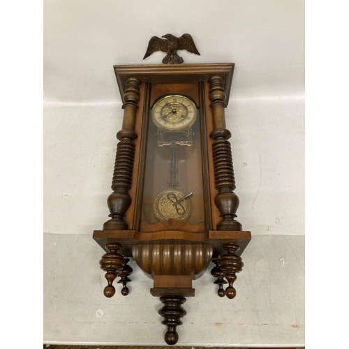 30 - A MAHOGANY CASED VIENNA WALL CLOCK WITH EAGLE DESIGN TOP, WITH PENDULUM AND KEY